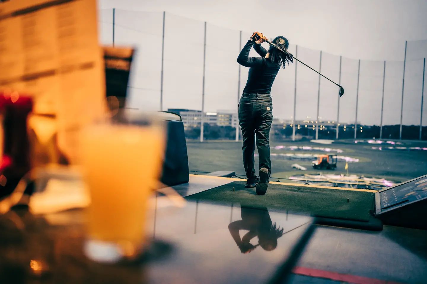 woman swinging a golf shot at Top Golf in Austin Texas